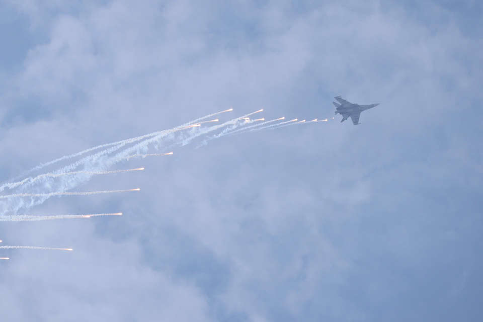 Vietnam's Su30 aircraft performs acrobatics and drops heat traps during a performance at the Opening Ceremony.