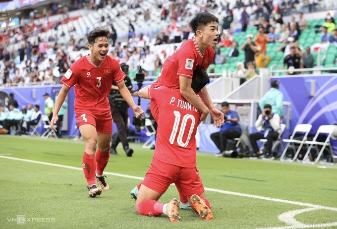 دينه باك يحتفل مع زملائه بالتعادل 1-1 في المباراة ضد اليابان في كأس آسيا 2023. تصوير: لام ثوا.