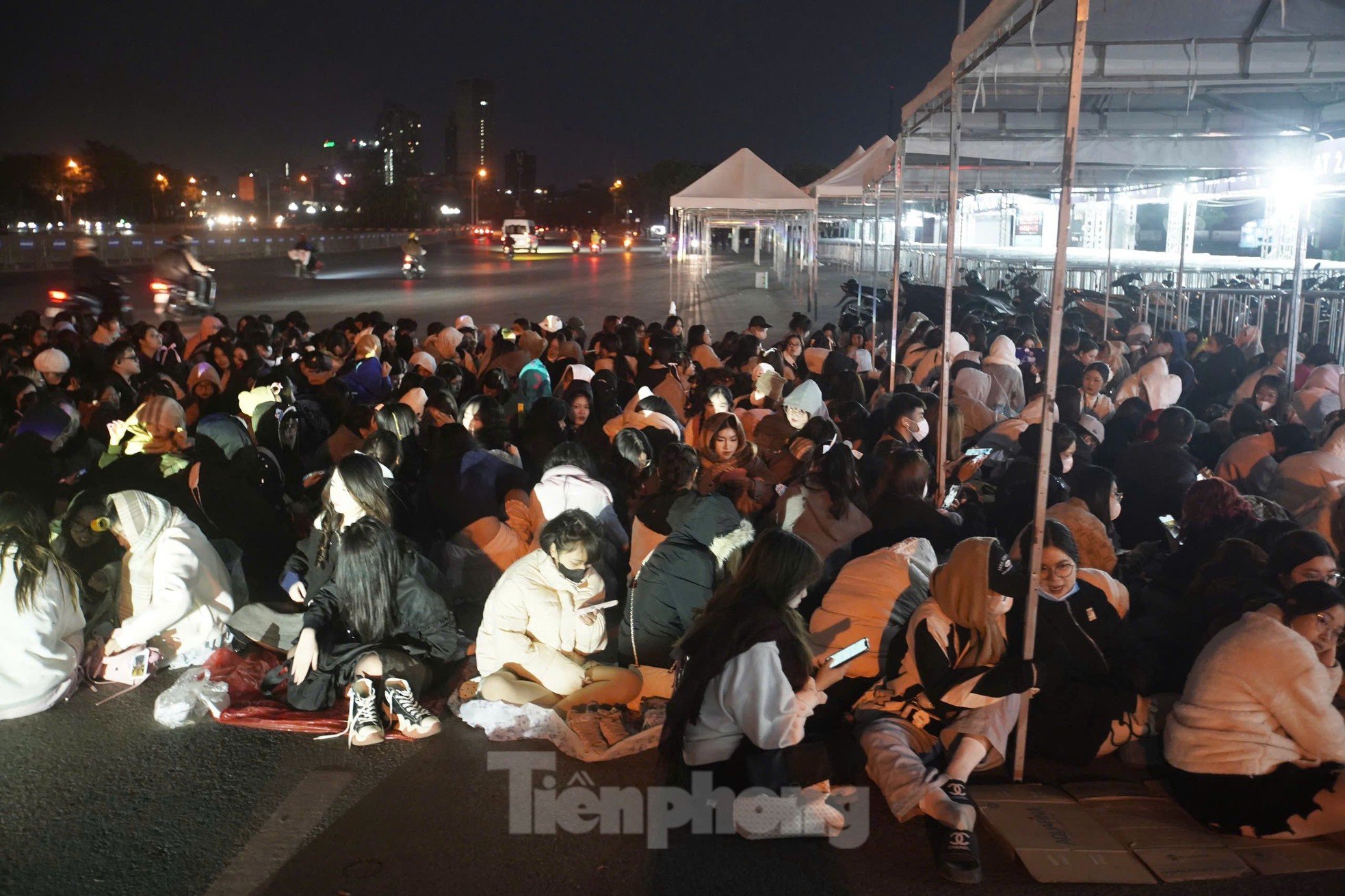 Long lines of spectators covered in scarves, sitting and sleeping right in front of My Dinh Stadium photo 3