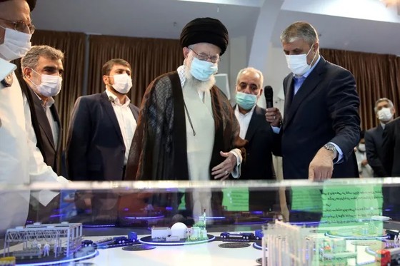 Iran's Supreme Leader Ayatollah Ali Khamenei listens to a presentation of a model of a nuclear facility. Photo: Asia News