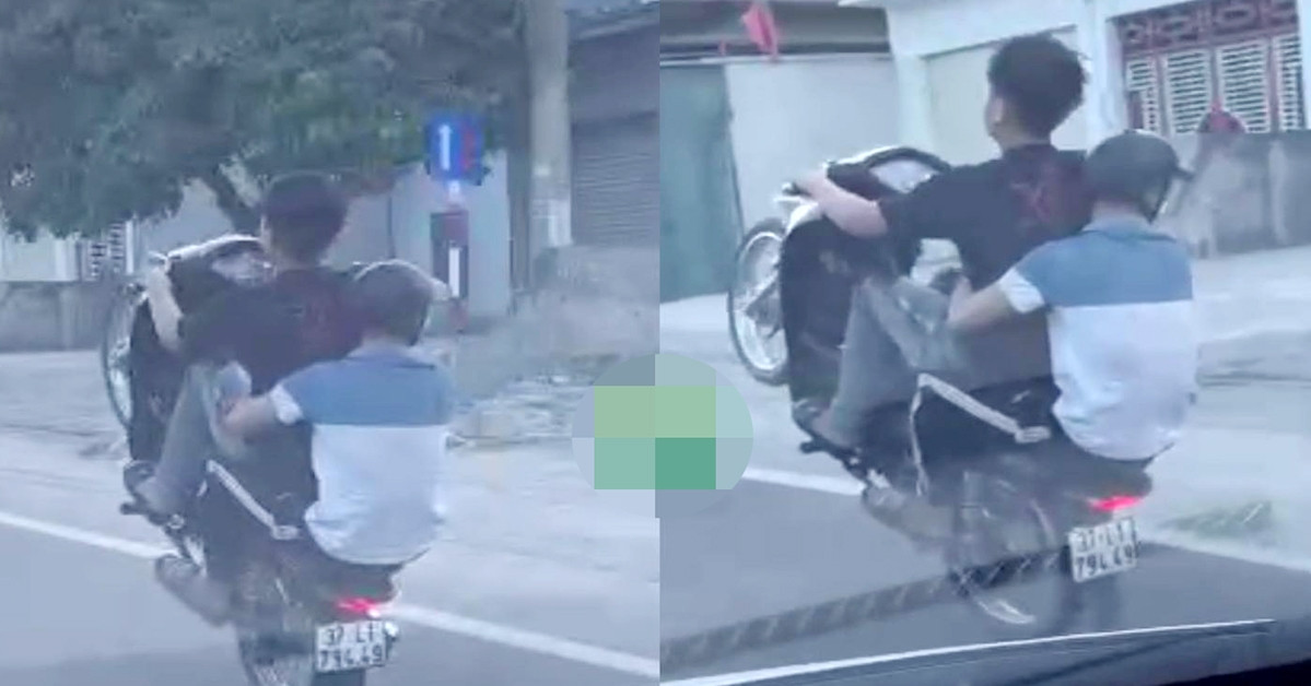 Young man brazenly rides a motorbike doing a wheelie on National Highway 1A