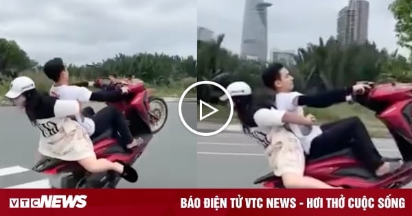 Young man carrying girl doing a wheelie on motorbike causes outrage