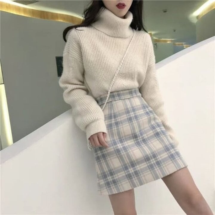 セーターとツイードスカートは、女の子にぴったりのエレガントで暖かい服装です。