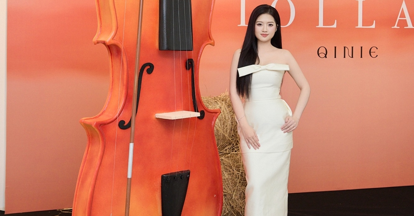 La belle violoniste Quynh Nhu est sexy à côté d'un violon géant