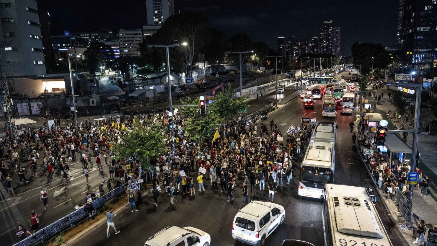 Israeli protesters holding banners and photos gather outside the defense ministry during a demonstration demanding ceasefire between Israel and Hamas and hostage swap deal in Tel Aviv, Israel on August 20, 2024.