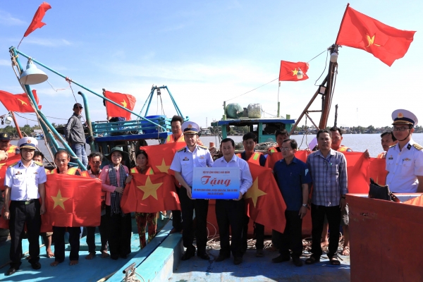 El Comando de la Región Naval 5 entrega 300 banderas nacionales a los pescadores de la provincia de Ca Mau