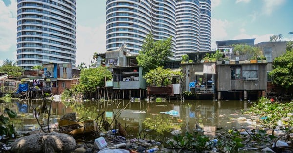 Scènes contrastées de maisons temporaires rafistolées le long des canaux de Ho Chi Minh-Ville