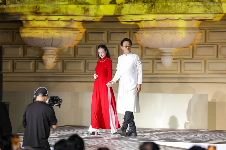 Tuan Hung holds hands with his wife Huong Baby as the vedette at 