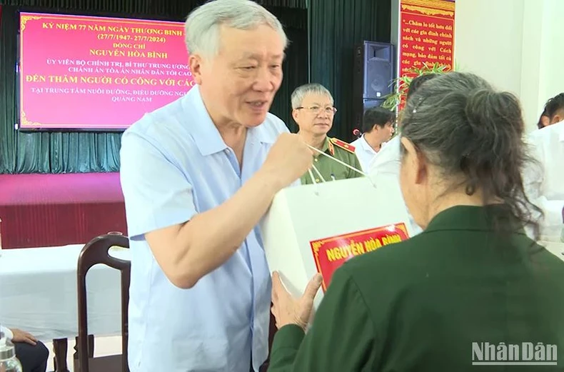 El presidente del Tribunal Popular Supremo, Nguyen Hoa Binh, visita y entrega regalos a las familias de los políticos en Quang Nam. Foto 1