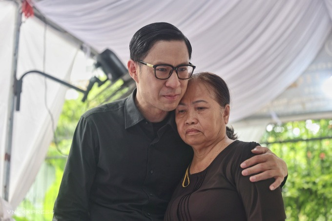 MC Anh Quan abrazó a la madre de Duc Tien para animarla, con la esperanza de que se mantuviera sana para poder encargarse de todo. Dijo que aún estaba conmocionado al enterarse de la mala noticia sobre su amigo cercano. La Sra. Ngoc Anh, de 65 años, conmocionada, le contó a Anh Quan que todo el vecindario se sorprendió al enterarse del fallecimiento de Duc Tien. Dijeron: «Una persona tan amable y gentil, ¿por qué tenía tanta mala suerte?».