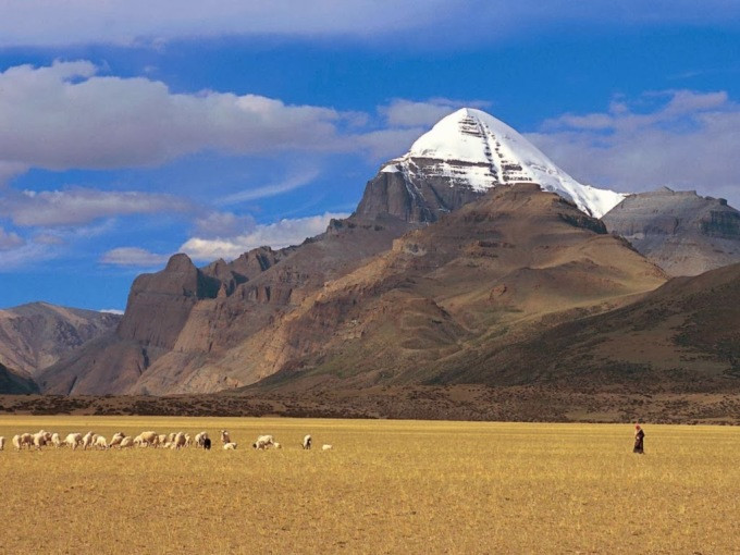 People graze cattle near the sacred mountain. Photo: Raghukul holidays