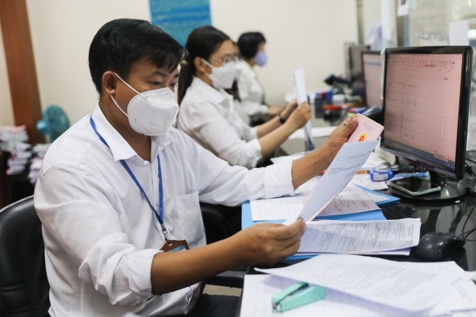 La gente realiza procedimientos administrativos en el Comité Popular de la ciudad de Thu Duc, agosto de 2022. Foto: Quynh Tran