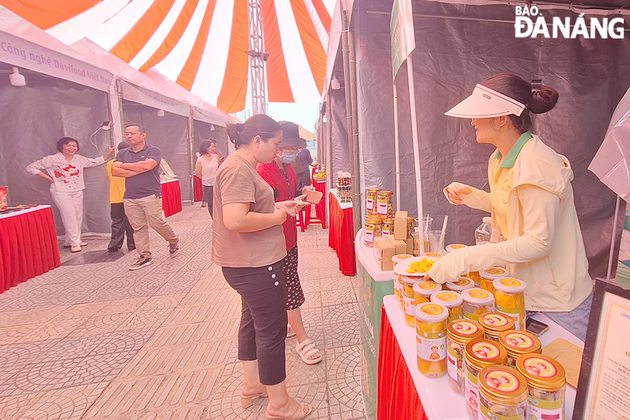 អ្នកស្រុក និងអ្នកទេសចរសាកល្បង និងពិសោធម្ហូបនៅក្នុងព្រឹត្តិការណ៍នេះ។ រូបថត៖ THU HA