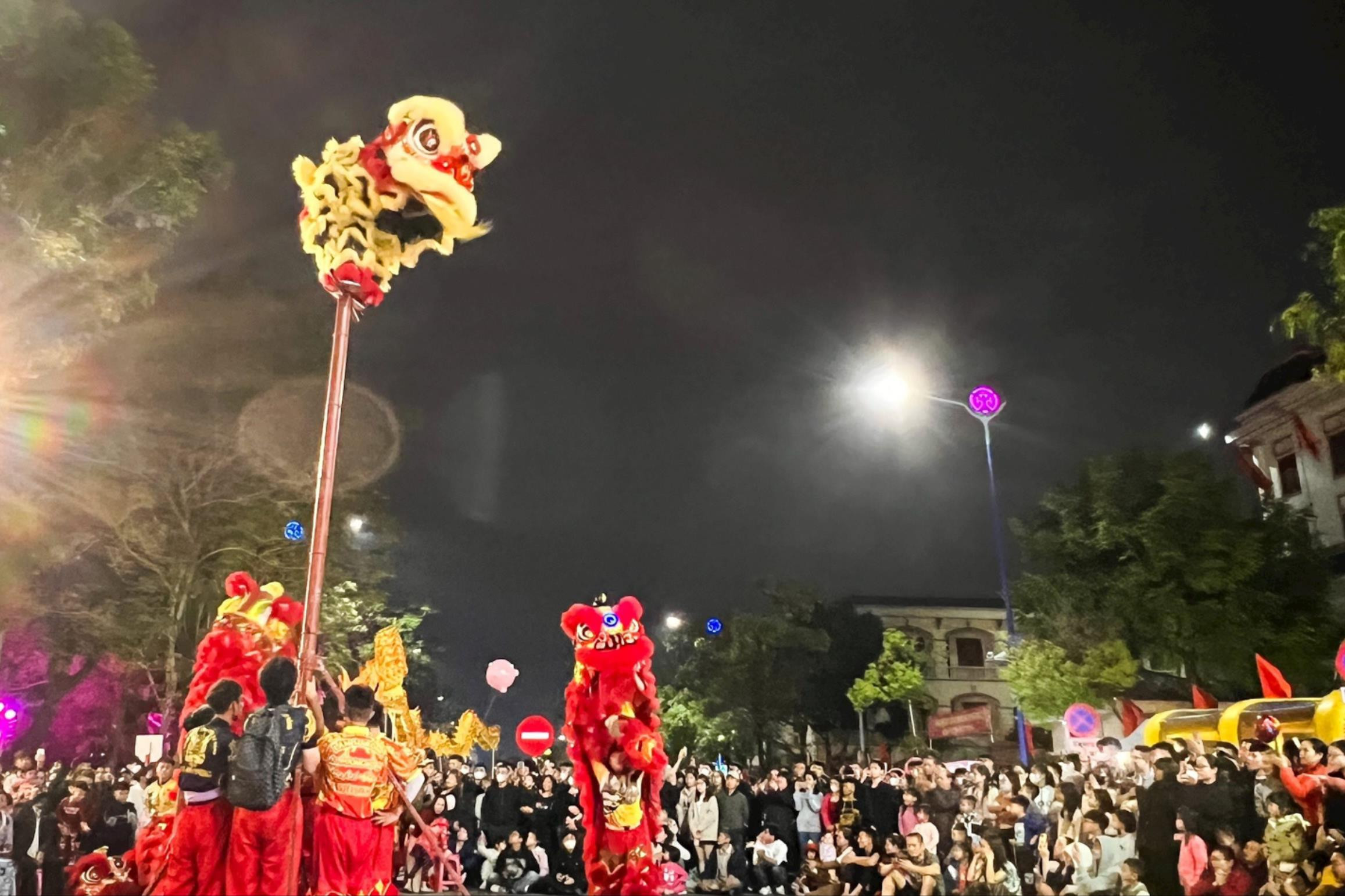 Danse amusante du lion dans la rue piétonne du marché nocturne de Bach Dang à l'occasion du Têt Giap Thin