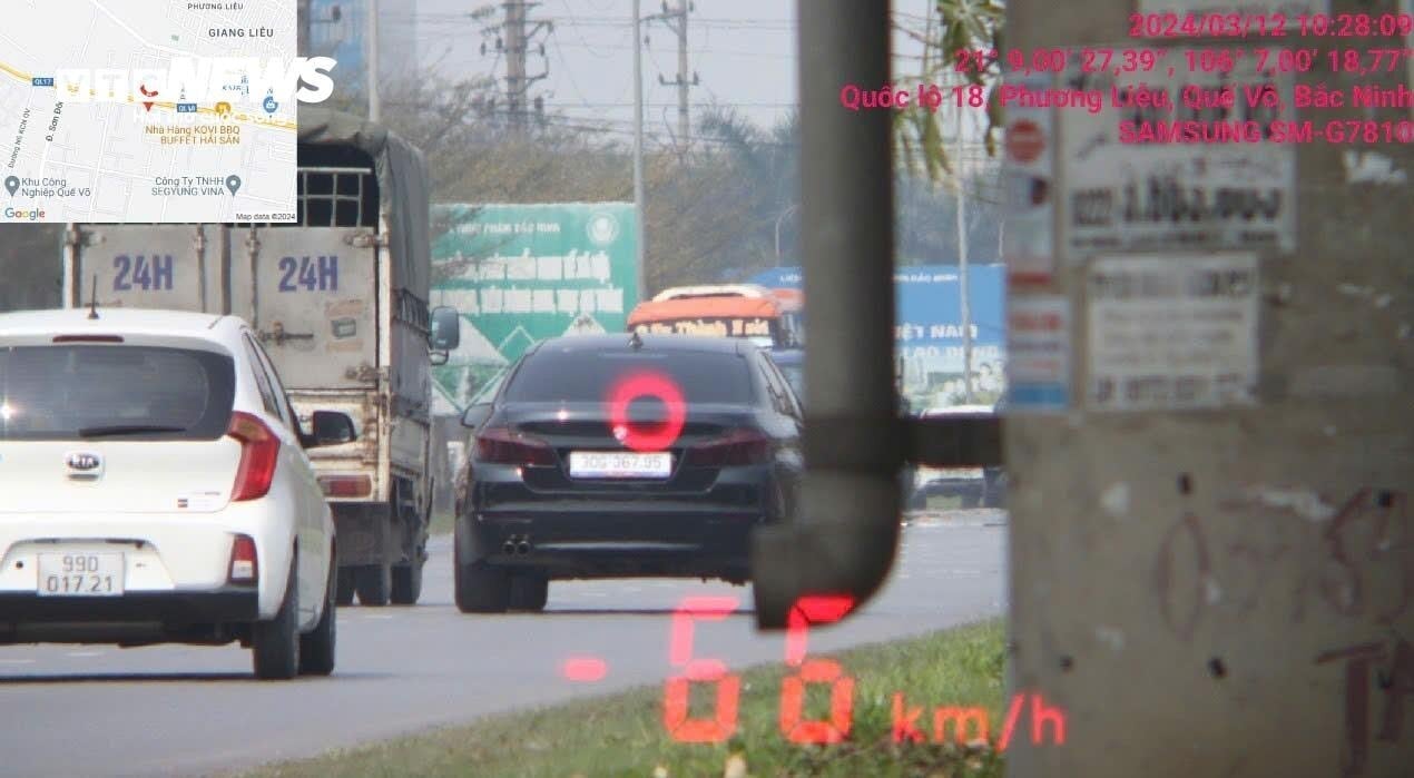 Car speeding on National Highway 18, through Que Vo town, Bac Ninh.