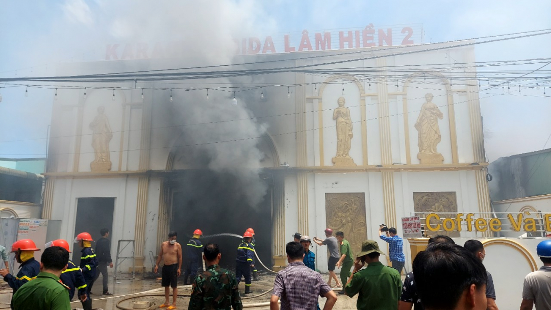 A large column of smoke billowed from the main door of the Karaoke bar.