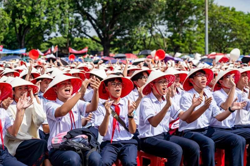 Thousands of students in the ancient capital of Hue wear conical hats to cheer for 