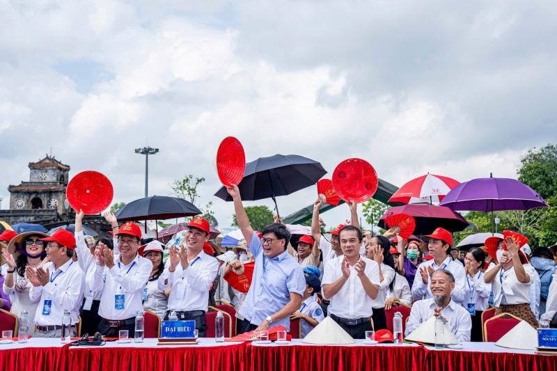 Thousands of students in the ancient capital of Hue wear conical hats to cheer for 