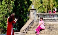 Young people wearing Ao Dai go to an ancient pagoda in Da Lat to take Tet photos