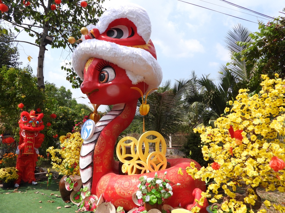 La mascotte serpent At Ty 2025 dans le quartier de Tuong Binh Hiep est drôle et mignonne avec le ton de couleur rouge principal, portant un chapeau de lion sur la tête et des graines oléagineuses sur ses oreilles - le symbole de la ville de Thu Dau Mot - est également un élément indispensable -sur place. sauter.