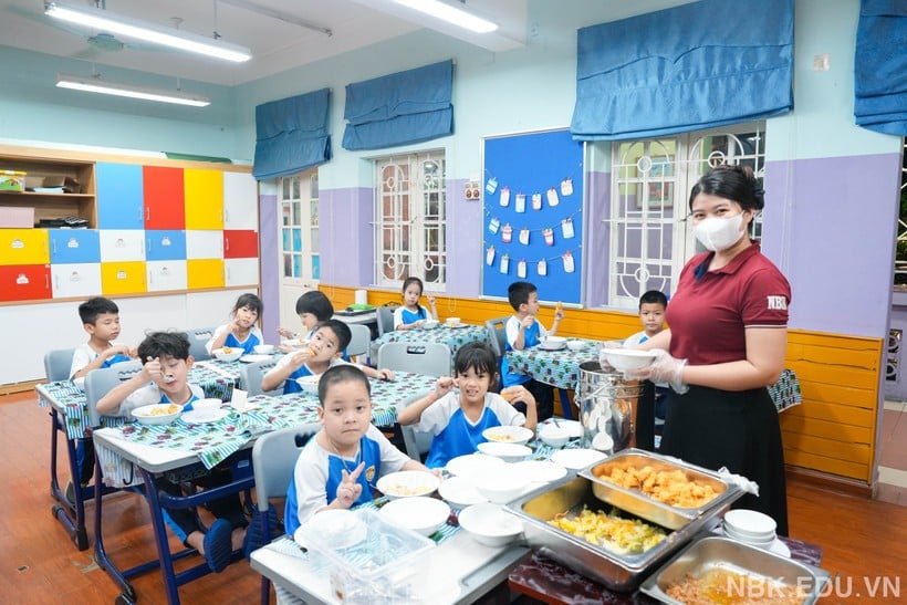 Students of Nguyen Binh Khiem School have dinner at school. (Photo: Provided by the school)