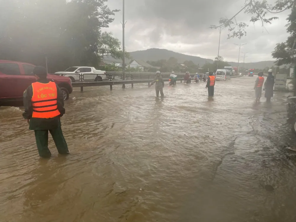 Authorities on duty to guide people and vehicles through flooded National Highway 1A