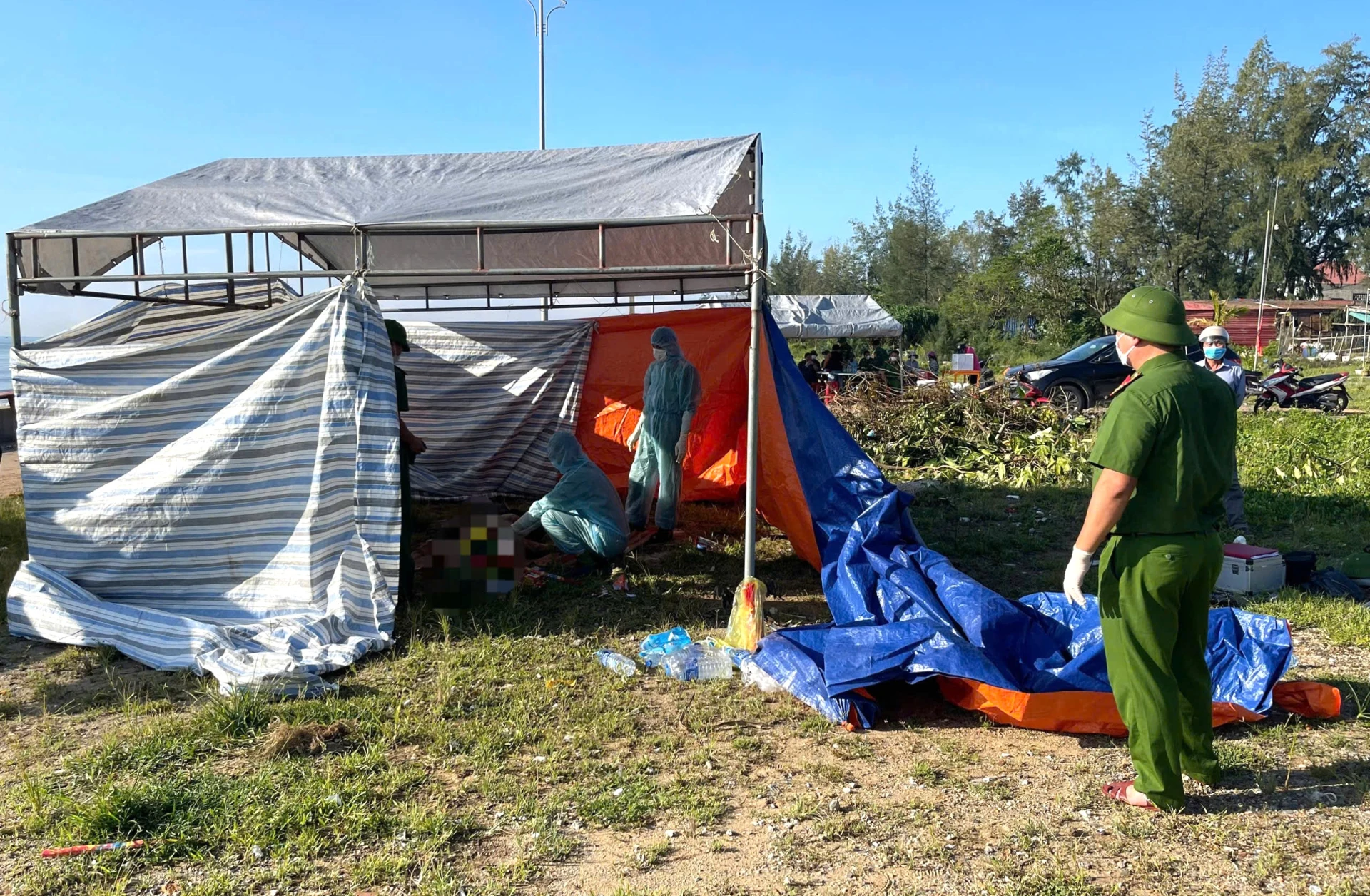 The victim's body was examined by authorities at the scene - Photo: Trung Duc
