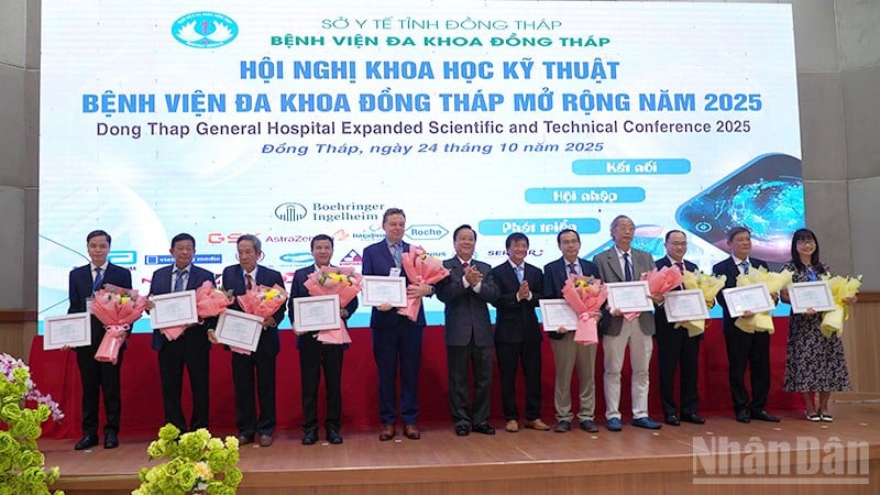 Leiders van het Dong Thap Algemeen Ziekenhuis overhandigden bloemen en certificaten voor deelname als voorzitter en verslaggever op de conferentie.