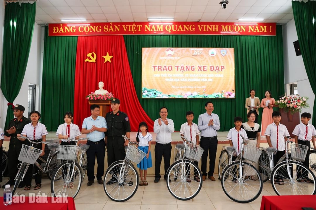 Lãnh đạo phường Tân An và Công ty trao xe đạp cho học sinh khó khăn.