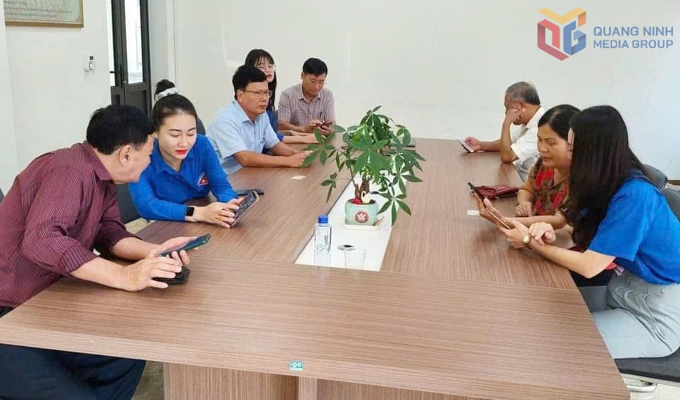 Membros da União da Juventude da Zona Econômica Especial de Van Don orientam pessoas sobre como usar aplicativos digitais em smartphones. Foto: Duong Truong