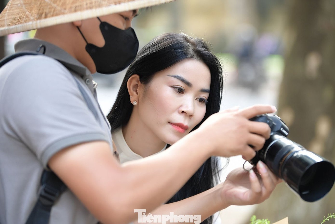 Young girls pose for photos on Phan Dinh Phung Street.