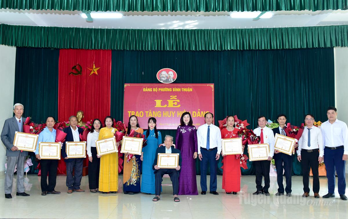 Místopředsedkyně Provinční lidové rady Pham Thi Minh Xuan a vedoucí představitelé obvodu Binh Thuan se na památku vyfotili s členy strany, kteří převzali stranické odznaky.