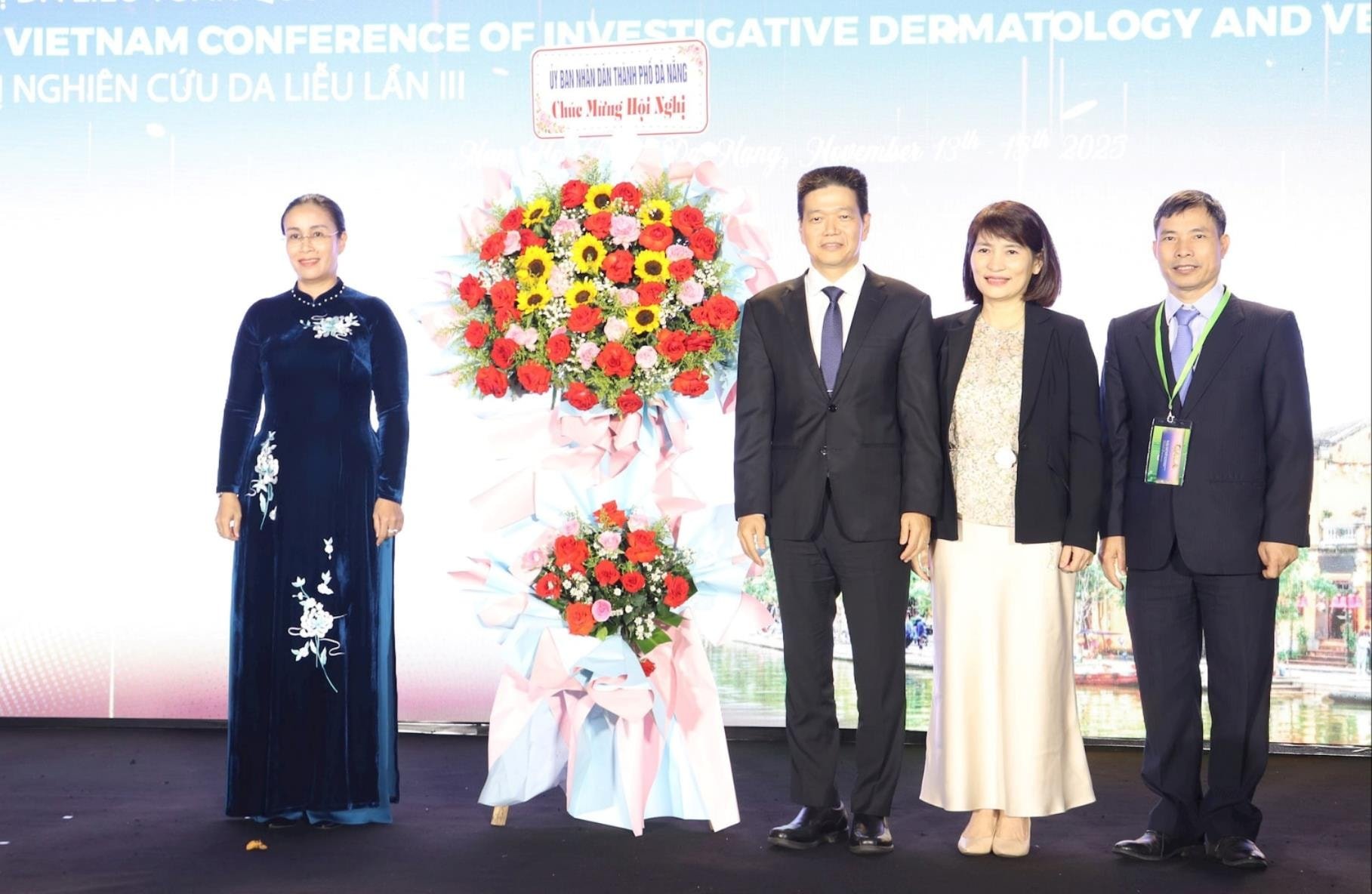 Vicevoorzitter van het Stadsvolkscomité Nguyen Thi Anh Thi (links) overhandigde bloemen ter felicitatie aan de conferentie. Foto: NGOC HA