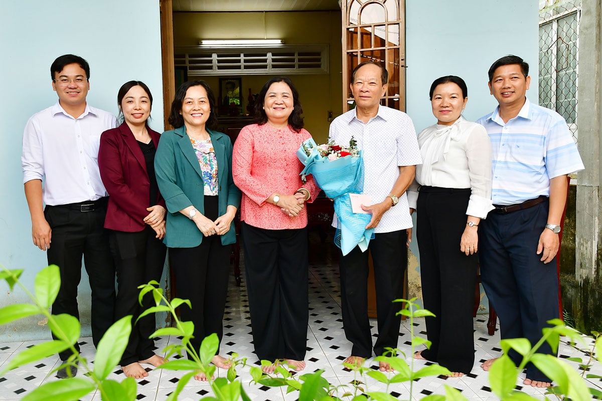 A camarada Ho Thi Hoang Yen, vice-secretária permanente do Comitê Provincial do Partido, e membros da delegação presentearam o camarada Nguyen Thanh Nguyen com flores e tiraram fotos de lembrança.