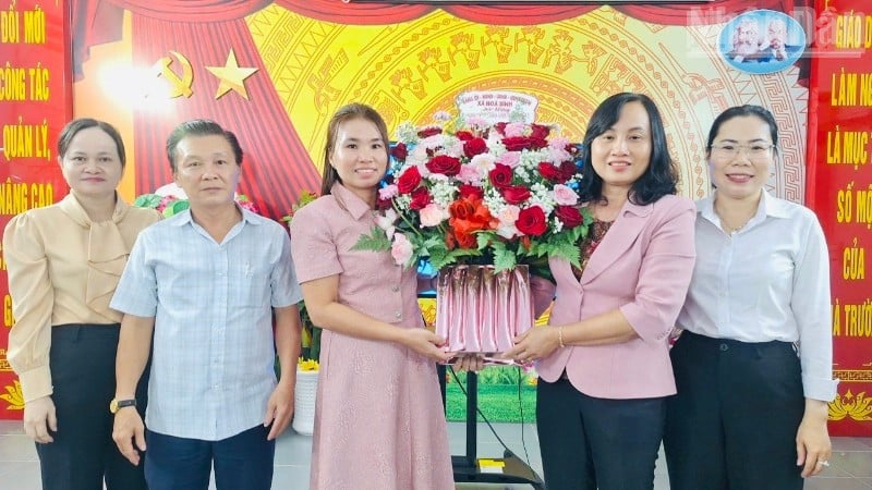 Soudruh Do Ai Lam, předseda Lidového výboru obce Hoa Binh (Ca Mau), také vedl zástupce odborů obce, kteří navštívili mateřskou školu Hoa Hong, darovali květiny a poblahopřáli jí. (Foto: HONG DAO)