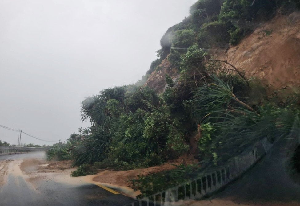 Đất đá và cây cối từ mái taluy dương trượt xuống, chắn ngang hơn nửa mặt đường. Ảnh: ĐT.