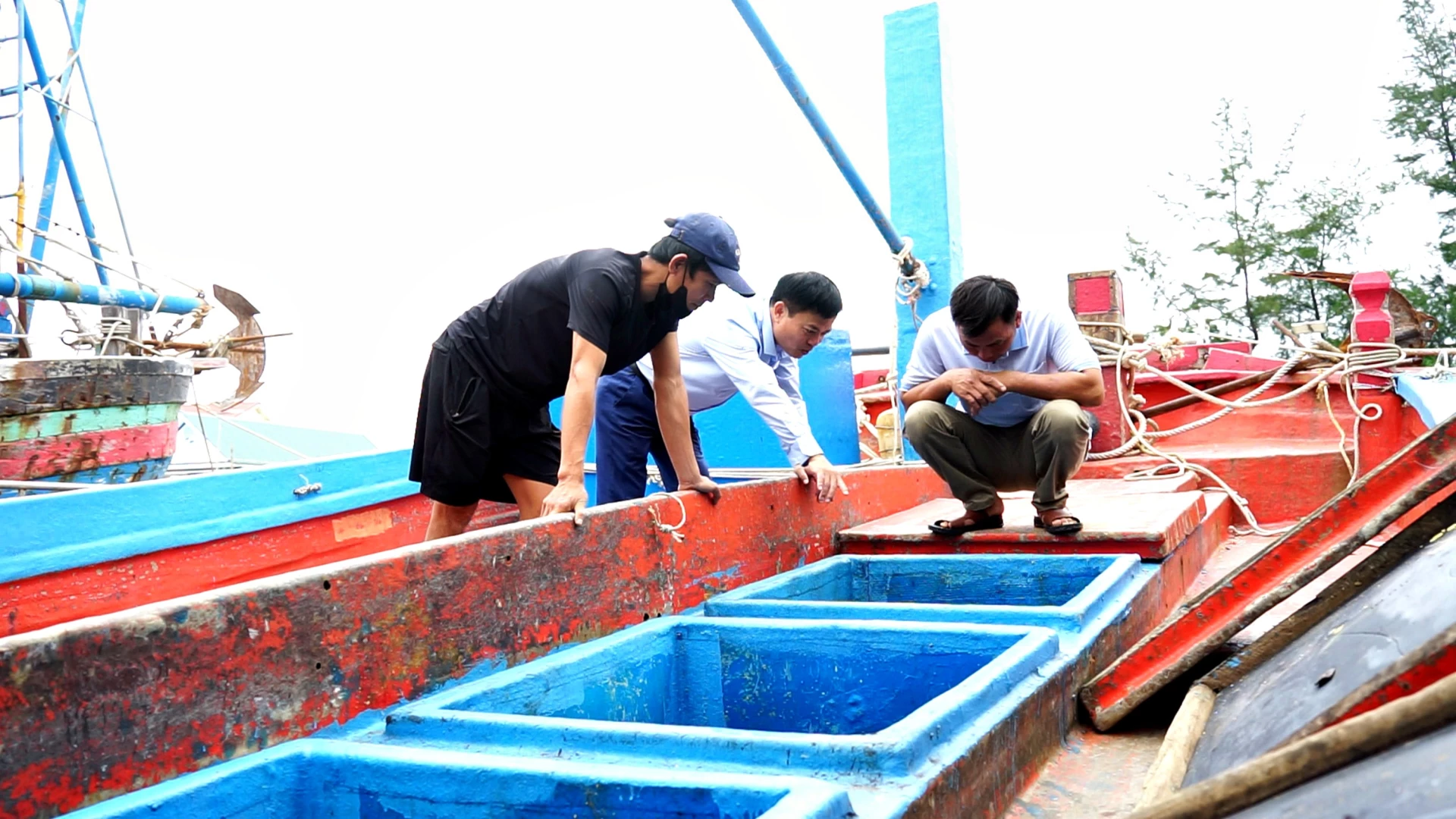 De heer Luong Van Hao (helemaal links) introduceert de productbewaarkelder die met CPF-technologie is gemaakt op zijn vissersboot - Foto: L.A.
