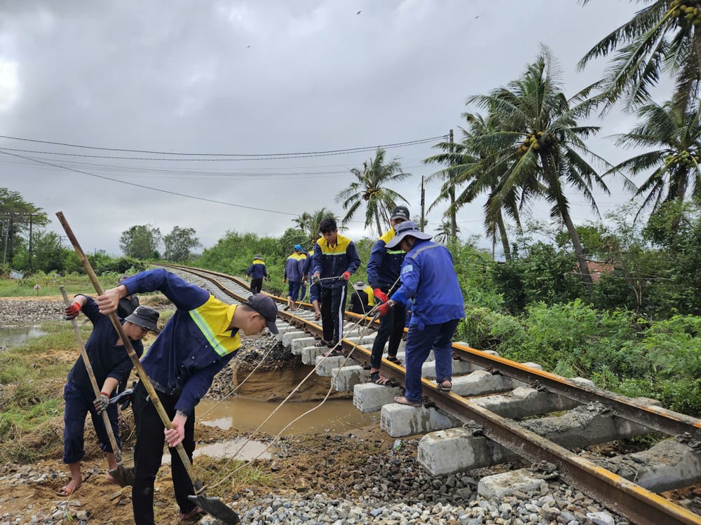 Des ouvriers des chemins de fer réparent les dégâts d'infrastructure causés par l'affaissement des voies ferrées suite aux inondations dans la région centrale. (Photo : VNR)