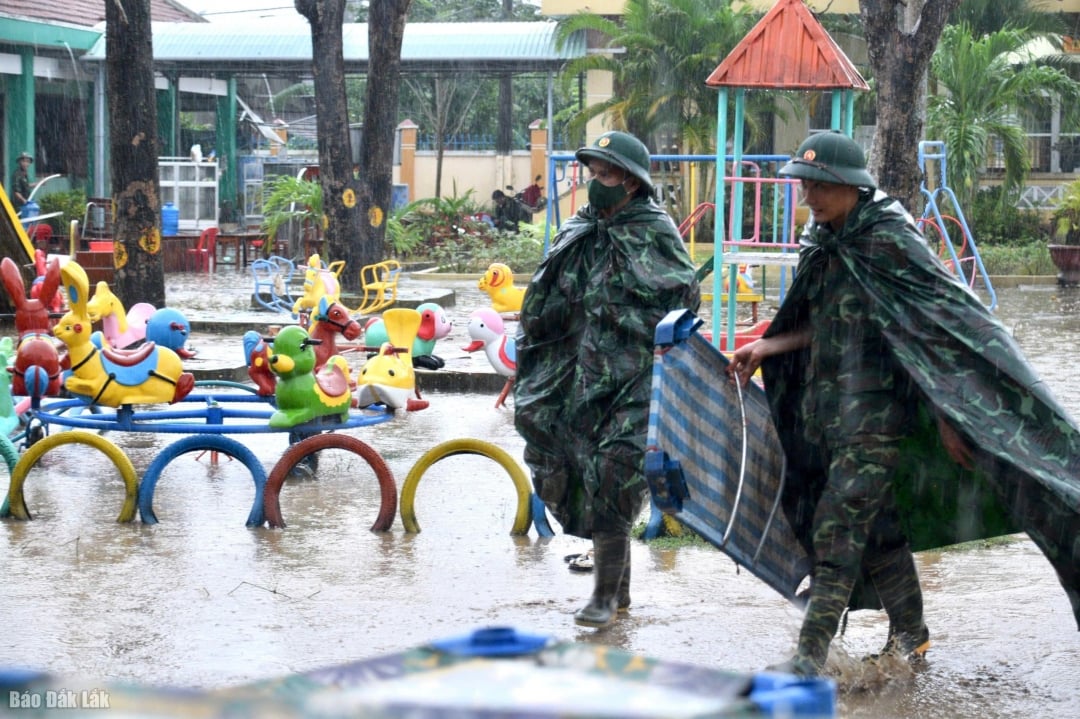 Żołnierze pracują w deszczu, sprzątając przedszkole w gminie Hoa Thinh.