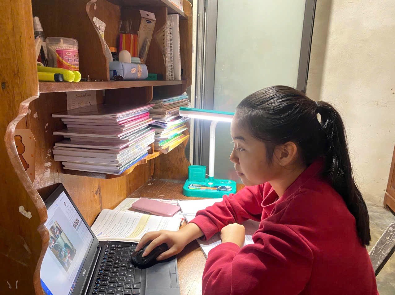 Nguyen Nha Khanh (klas 8B, Ba Long Secondary School) loopt naar haar bureau wanneer de luidspreker het signaal geeft dat het tijd is om te studeren.