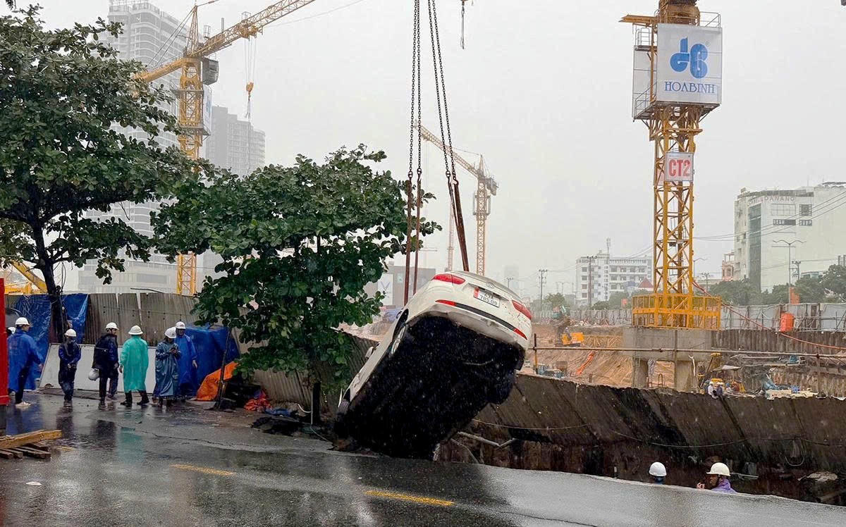 Autoritățile au mobilizat utilaje pentru a ridica mașina care a căzut în groapă.