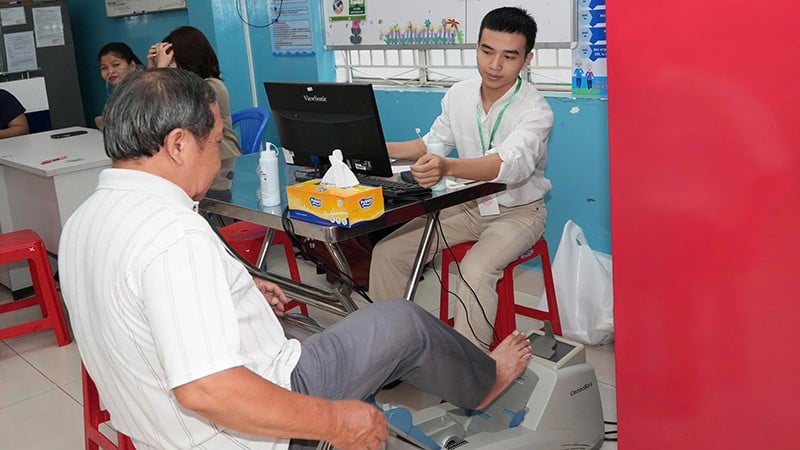 A Vietnami Alkalmazott Orvostudományi Intézet szakértői egy táplálkozási felmérésben részt vevő időseket vizsgálnak és látnak el egészségügyi ellátásban.