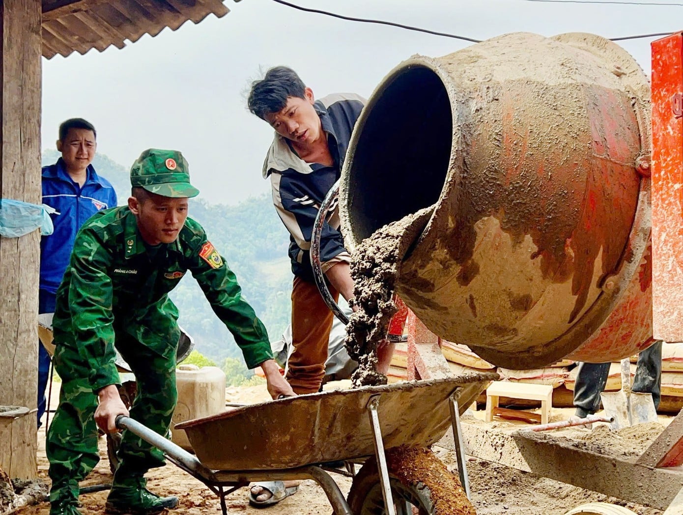 שומרי גבול עוזרים לאנשים להעביר חומרים לבניית בתים חדשים.