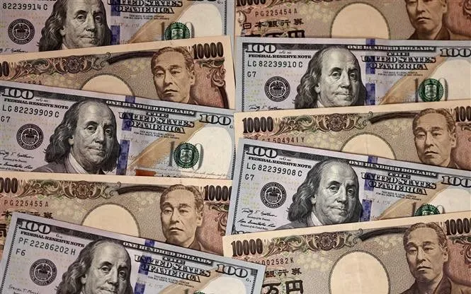 Tiền giấy mệnh giá 10.000 yen và 100 USD tại Tokyo, Nhật Bản. (Ảnh: AFP/TTXVN)