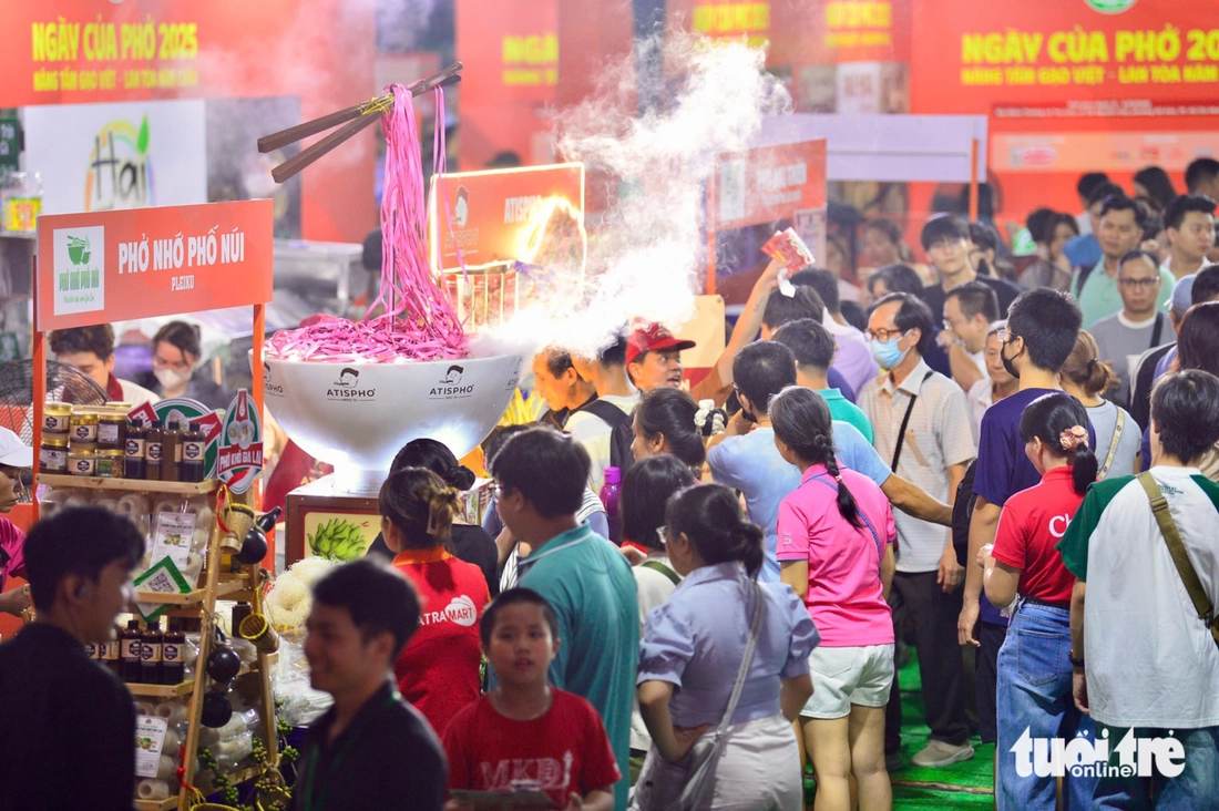 A noite do Dia do Pho estava agitada, com algumas barracas servindo mais de mil tigelas sem parar - Foto 4. Buổi tối nhộn nhịp tại Ngày của Phở, người dân xếp hàng chờ đến lượt, có tiệm phục vụ cả ngàn tô - Ảnh 4.