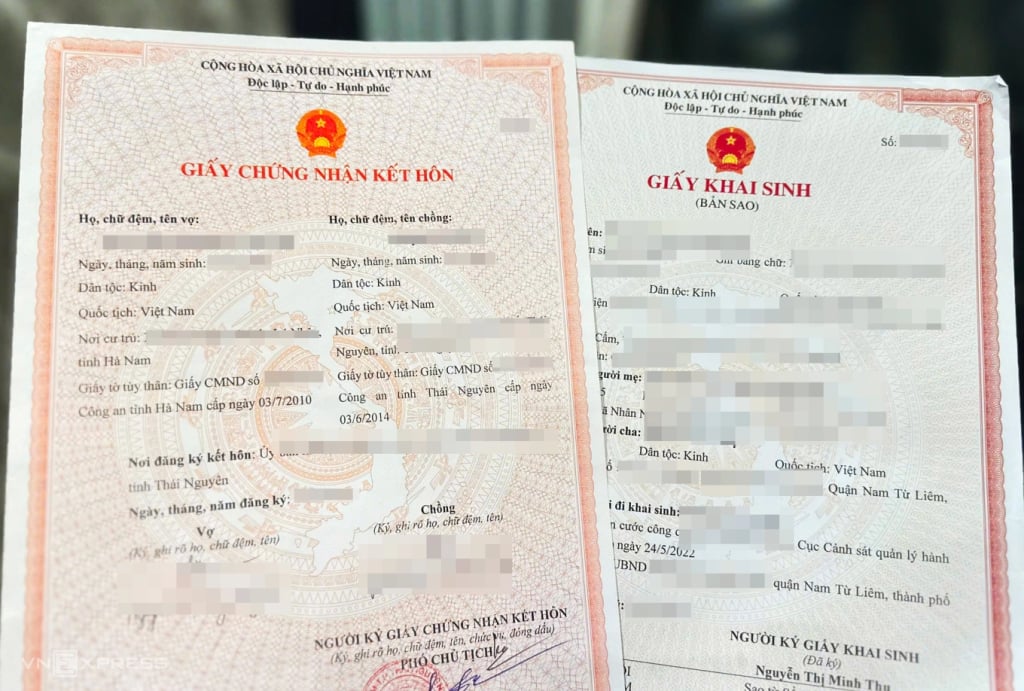 Paper copies of marriage certificate and birth certificate. Photo: Pham Du