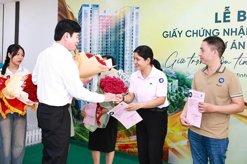 Đại diện tập đoàn Lê Phong trao giấy chứng nhận quyền sở hữu căn hộ và hoa cho cư dân.