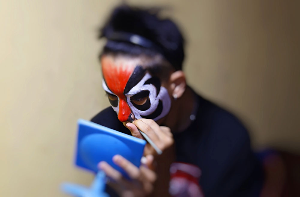 The artist's hands are meticulous in the makeup process.