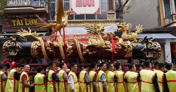 Thousands of people carry two giant fireworks