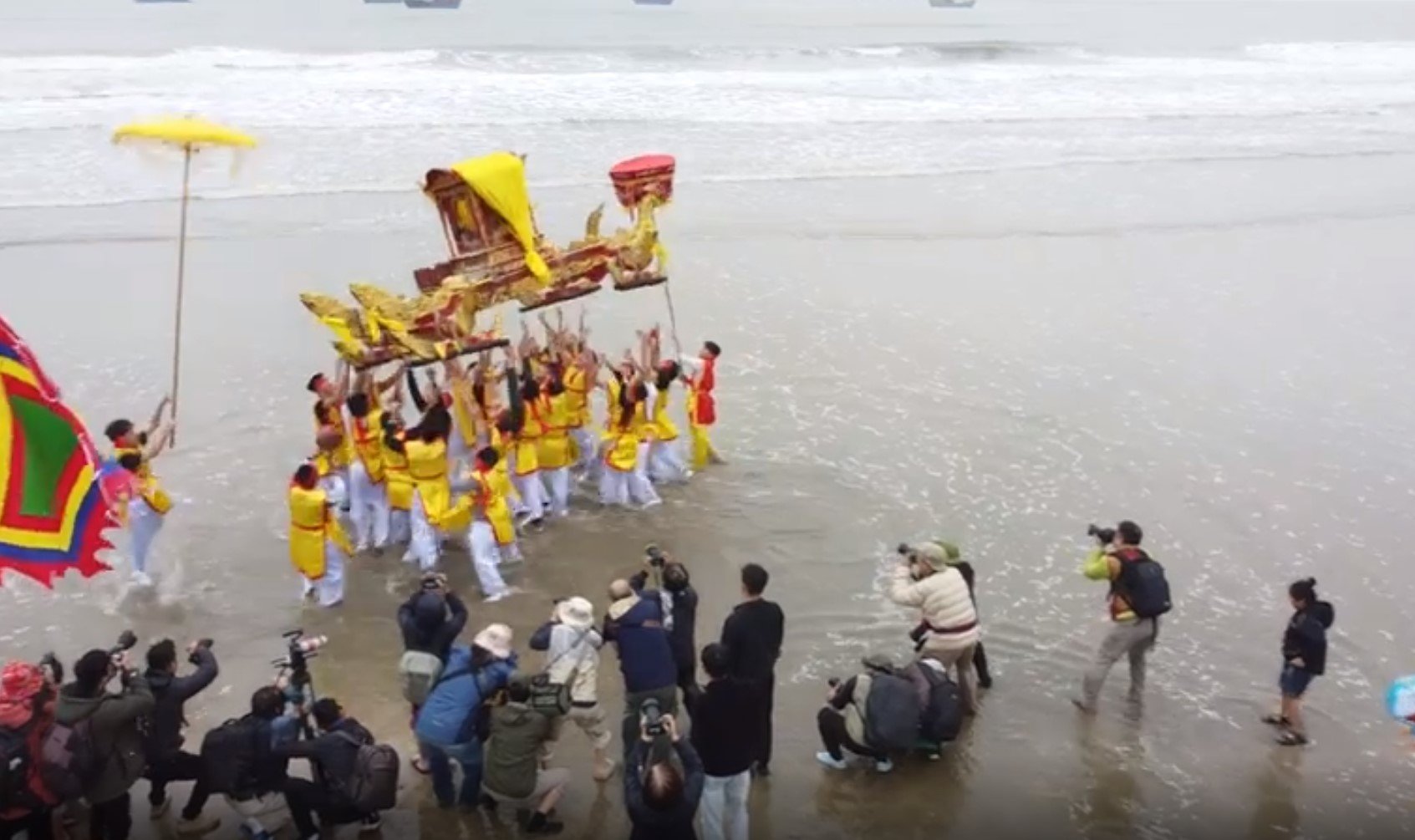 Men from the fishing village carry a 'flying palanquin' in a run to vomit and jostle for blessings at the Con Temple Festival